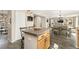 Open-concept kitchen features a large island, wood cabinets, and hardwood floors at 6280 Snowberry Ave, Firestone, CO 80504
