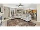 Spacious living room with hardwood floors, a decorative rug, and natural light from large windows at 6280 Snowberry Ave, Firestone, CO 80504