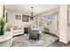 Bright living room featuring large windows, comfortable seating, and a decorative area rug at 6280 Snowberry Ave, Firestone, CO 80504