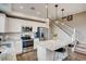 A well-lit kitchen with white cabinets, granite countertops, and stainless steel appliances at 17153 W 91St Ln, Arvada, CO 80007