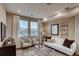 Bright living room with a comfy seating area, modern decor, large windows, and recessed lighting at 17153 W 91St Ln, Arvada, CO 80007