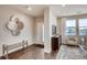 Welcoming foyer with a bench seat, decorative wall decor, and views into the living area at 17153 W 91St Ln, Arvada, CO 80007