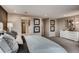 Spacious main bedroom with soft carpet, neutral walls, contemporary art, and a bright white dresser at 17153 W 91St Ln, Arvada, CO 80007