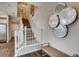 Stairway with carpeted steps and white railing, complemented by modern wall decor and natural light at 17153 W 91St Ln, Arvada, CO 80007