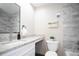 A modern bathroom features white marble and vanity with granite countertops and a large mirror above the sink at 15045 E Louisiana Dr # B, Aurora, CO 80012