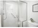 This bathroom features a large shower with glass doors, a built-in seat, and a handrail for convenience at 15045 E Louisiana Dr # B, Aurora, CO 80012