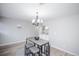 Minimalist dining area features modern light fixture and built in shelving, cabinets and countertop at 15045 E Louisiana Dr # B, Aurora, CO 80012