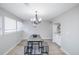 Inviting dining room with modern table, bench seating, and stylish chandelier fixture at 15045 E Louisiana Dr # B, Aurora, CO 80012