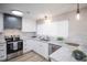 Modern kitchen with stainless steel appliances, bright white cabinetry, and sleek countertops at 15045 E Louisiana Dr # B, Aurora, CO 80012