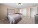 Bedroom featuring neutral carpeting, natural light, and access to ensuite bathroom at 6339 S Langdale Way, Aurora, CO 80016