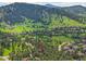 Scenic aerial view of the property nestled within a lush, green landscape with neighboring houses at 23485 Bluestem Dr, Golden, CO 80401
