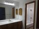Bathroom with vanity and mirror leading to the tiled shower and tub at 23485 Bluestem Dr, Golden, CO 80401
