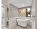 Bathroom with freestanding tub, separate shower, and modern fixtures at 23485 Bluestem Dr, Golden, CO 80401