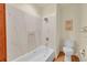 Bathroom featuring tile, a shower head, towel rack, and toilet at 23485 Bluestem Dr, Golden, CO 80401