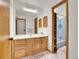 Bright bathroom featuring a classic vanity with a large mirror and separate shower at 23485 Bluestem Dr, Golden, CO 80401