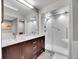 Modern bathroom featuring dual sinks, marble countertops, and glass-enclosed shower at 23485 Bluestem Dr, Golden, CO 80401