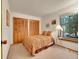 Comfortable bedroom featuring a queen-sized bed, double closet, and natural light from the window at 23485 Bluestem Dr, Golden, CO 80401
