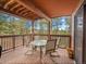 Covered deck with outdoor seating and views of the trees at 23485 Bluestem Dr, Golden, CO 80401