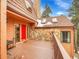 Spacious deck with a red door and stone accents, ideal for outdoor entertaining and relaxation at 23485 Bluestem Dr, Golden, CO 80401