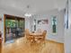 Bright dining room with hardwood floors, wood table and chairs, and sliding glass door to deck at 23485 Bluestem Dr, Golden, CO 80401