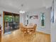 Bright dining room featuring wood floors, a modern chandelier, and access to the outdoor deck at 23485 Bluestem Dr, Golden, CO 80401