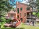 Exterior showcasing multiple decks, a hot tub, wood siding, and a fenced area at 23485 Bluestem Dr, Golden, CO 80401