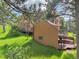Side exterior view of home featuring multiple wooden decks and set against a backdrop of trees at 23485 Bluestem Dr, Golden, CO 80401