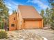 Rustic exterior showcasing a two-car garage and multiple decks for outdoor enjoyment at 23485 Bluestem Dr, Golden, CO 80401