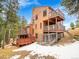 A-frame home with wrap-around deck and fenced yard at 23485 Bluestem Dr, Golden, CO 80401