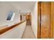 Bright hallway with skylight and wooden accents leads to the staircase at 23485 Bluestem Dr, Golden, CO 80401