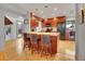 Stylish kitchen with wooden cabinets, stone countertop, island with seating and black appliances at 23485 Bluestem Dr, Golden, CO 80401