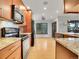 Well-lit kitchen with stainless steel appliances, granite countertops, and hardwood floors at 23485 Bluestem Dr, Golden, CO 80401