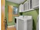 Functional laundry room with modern washer and dryer, and built-in cabinets at 23485 Bluestem Dr, Golden, CO 80401