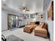 Cozy living room featuring plush seating, a ceiling fan, built-in shelving, and access to the outdoor deck at 23485 Bluestem Dr, Golden, CO 80401