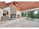 Inviting living room with stone fireplace, wood ceiling, and sliding glass doors to outside deck at 23485 Bluestem Dr, Golden, CO 80401