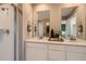 Contemporary bathroom features double sinks, a spacious shower, and neutral tones at 495 Bennett Ave, Bennett, CO 80102