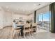 Open dining area adjacent to the kitchen, featuring a modern table and ample natural light at 495 Bennett Ave, Bennett, CO 80102