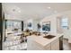 Bright open-concept kitchen flows into the living and dining area, perfect for entertaining at 495 Bennett Ave, Bennett, CO 80102