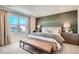 Serene bedroom with a statement wall, plush bedding, and ample natural light at 495 Bennett Ave, Bennett, CO 80102