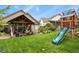 Spacious backyard featuring a covered patio and a playset, perfect for outdoor entertaining and recreation at 1762 Granger Cir, Castle Rock, CO 80109