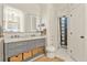 Elegant bathroom featuring double sinks, marble countertops, and stylish storage baskets at 1762 Granger Cir, Castle Rock, CO 80109