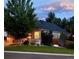 Beautiful landscaped lawn and garden beds surround this lovely home with its welcoming covered front porch at 1762 Granger Cir, Castle Rock, CO 80109