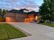 Charming brick home featuring a large driveway, attached three-car garage, and welcoming covered front porch at 1762 Granger Cir, Castle Rock, CO 80109
