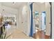 Bright hallway featuring tile floors and views into the adjacent living spaces at 1762 Granger Cir, Castle Rock, CO 80109