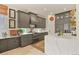 Beautiful kitchen features gray cabinets, stone countertops, stainless appliances, and a large island at 1762 Granger Cir, Castle Rock, CO 80109