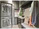 Modern laundry room with stacked washer/dryer, utility sink, and ample storage cabinets for efficient cleaning at 1762 Granger Cir, Castle Rock, CO 80109