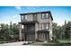 A modern, three-story home features stone accents, a balcony, and a two-car garage at 3179 S Russell St, Morrison, CO 80465
