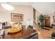 Bright dining area with a large table, black chairs, and seamless access to the staircase and front door at 2986 S Fundy Ct, Aurora, CO 80013