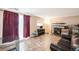 Cozy living room featuring a fireplace, tile flooring, and a comfortable couch at 2986 S Fundy Ct, Aurora, CO 80013