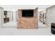 Finished basement with a brick accent wall and tv area leading to a walk-in closet at 680 S Ogden St, Denver, CO 80209